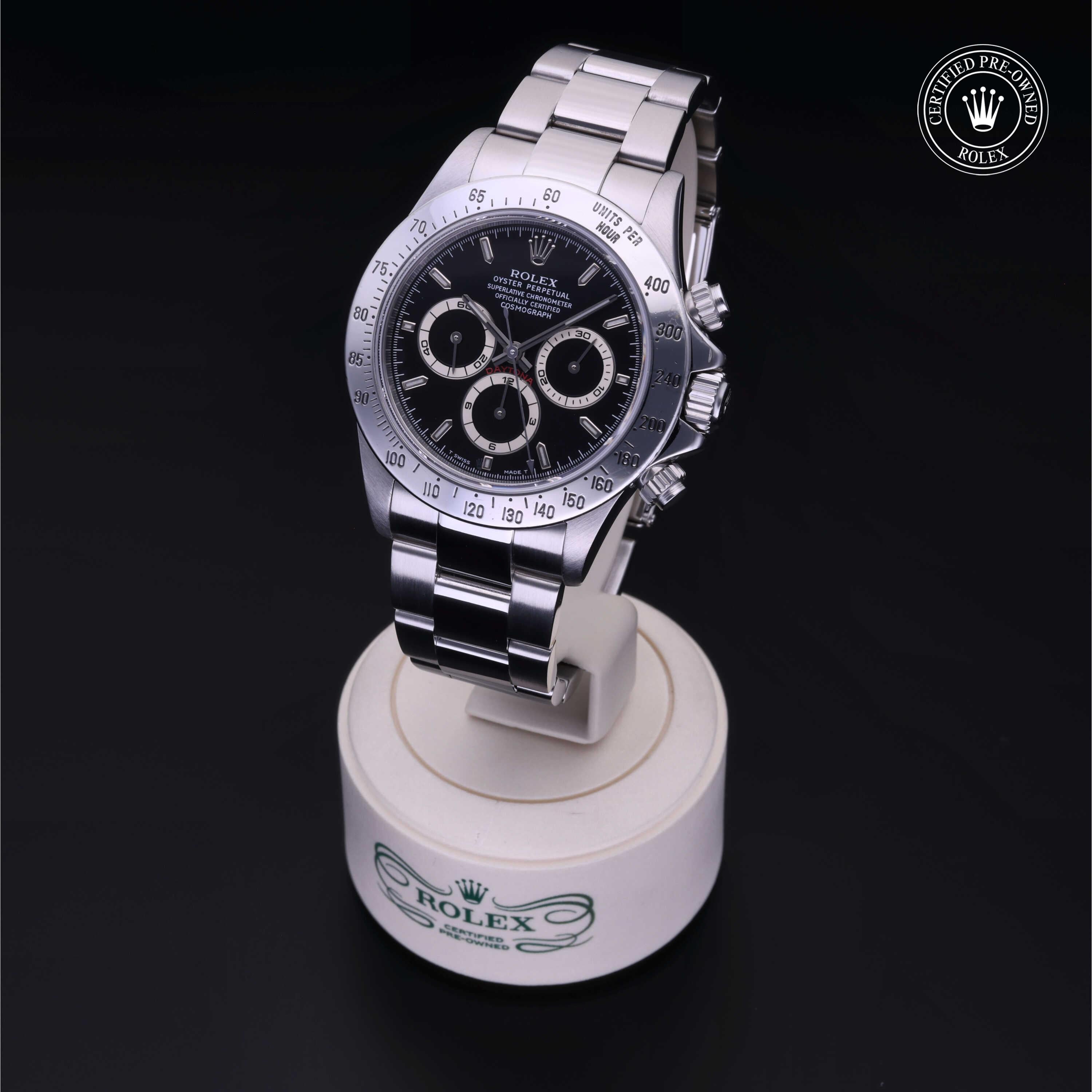 Stainless steel Rolex chronograph wristwatch with black dial on a display stand, featuring a certified pre-owned Rolex logo in the upper corner.