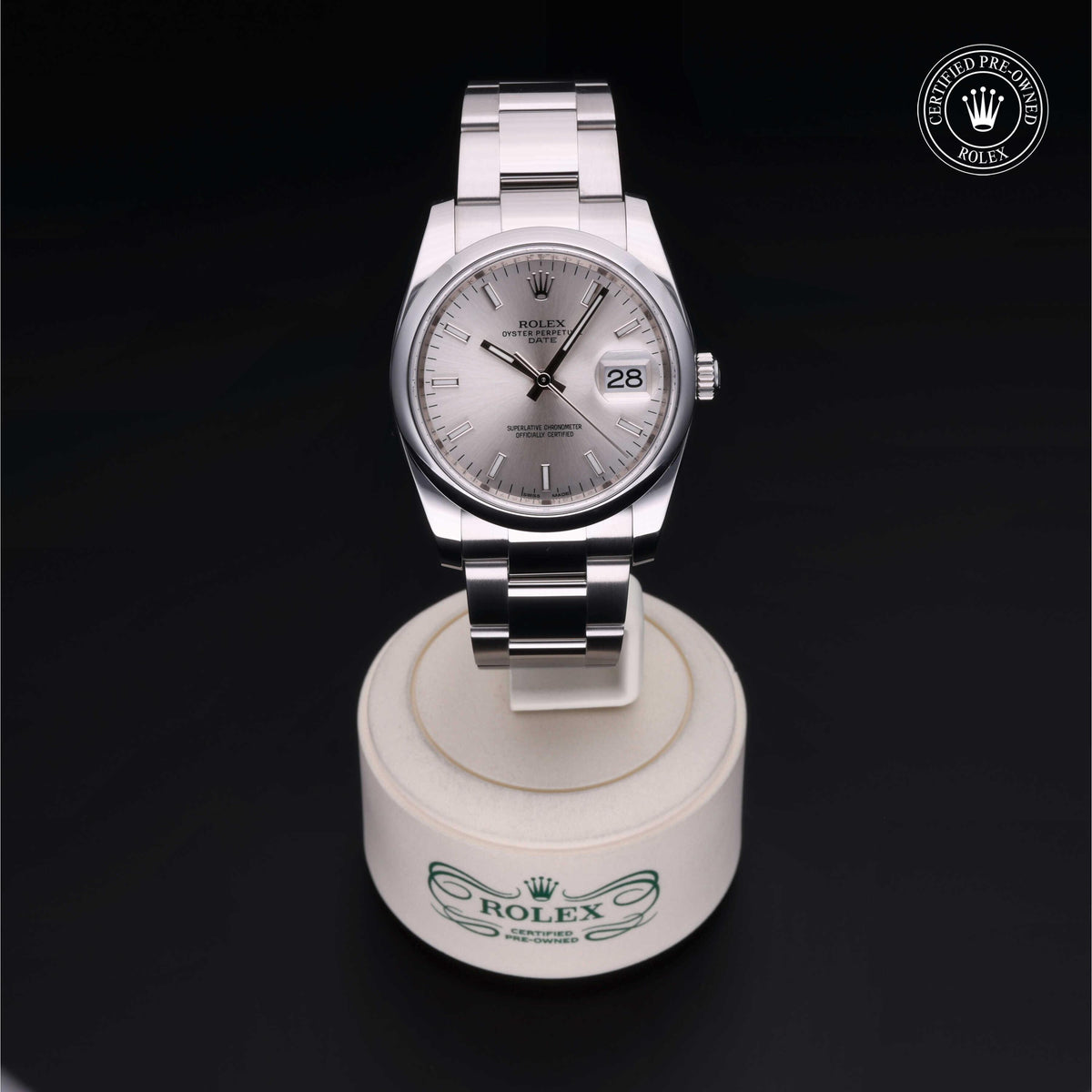 A luxury Rolex watch with a silver dial and date display on a white stand, showcasing fine craftsmanship and elegance, perfect for those seeking luxury jewelry and timepieces.