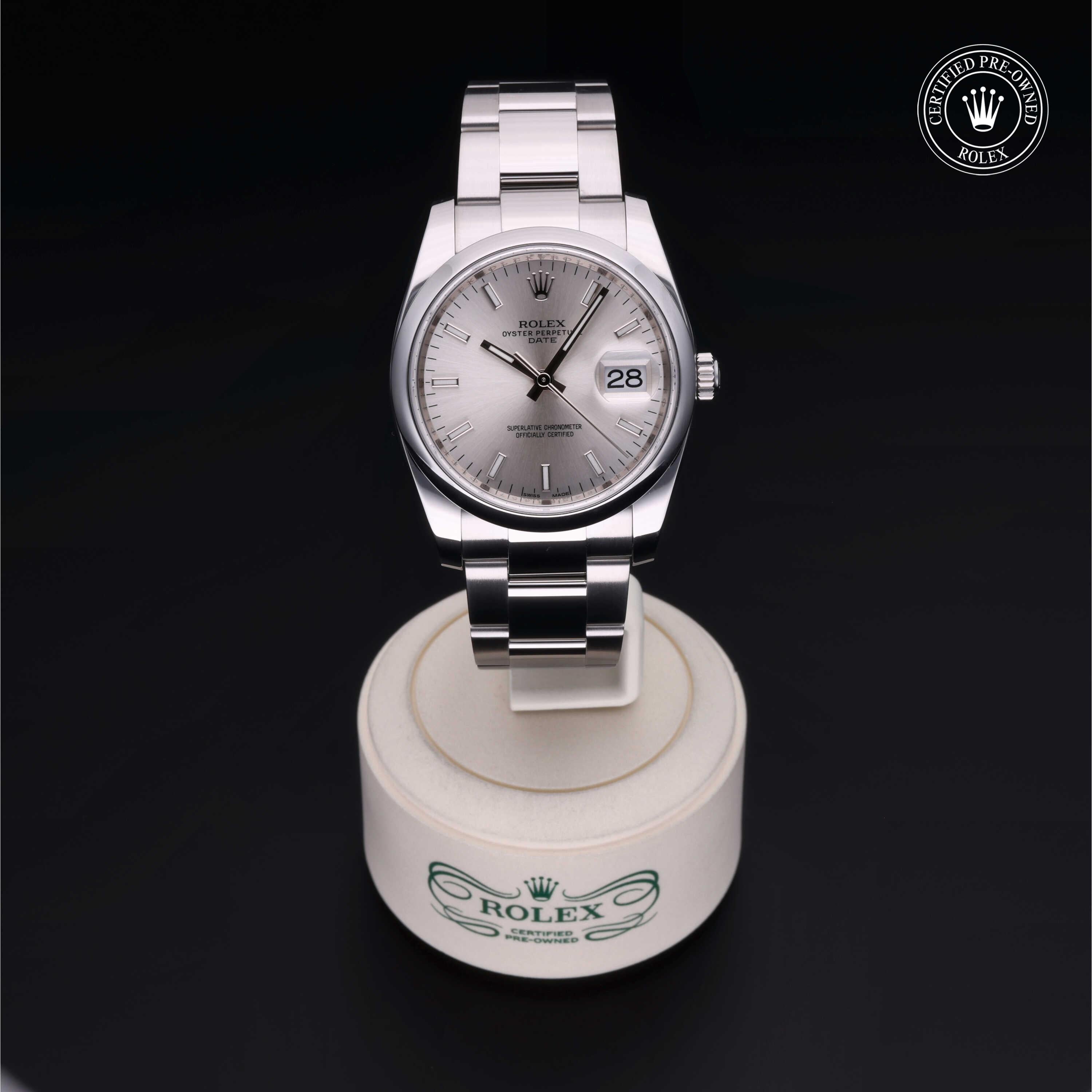 A luxury Rolex watch with a silver dial and date display on a white stand, showcasing fine craftsmanship and elegance, perfect for those seeking luxury jewelry and timepieces.