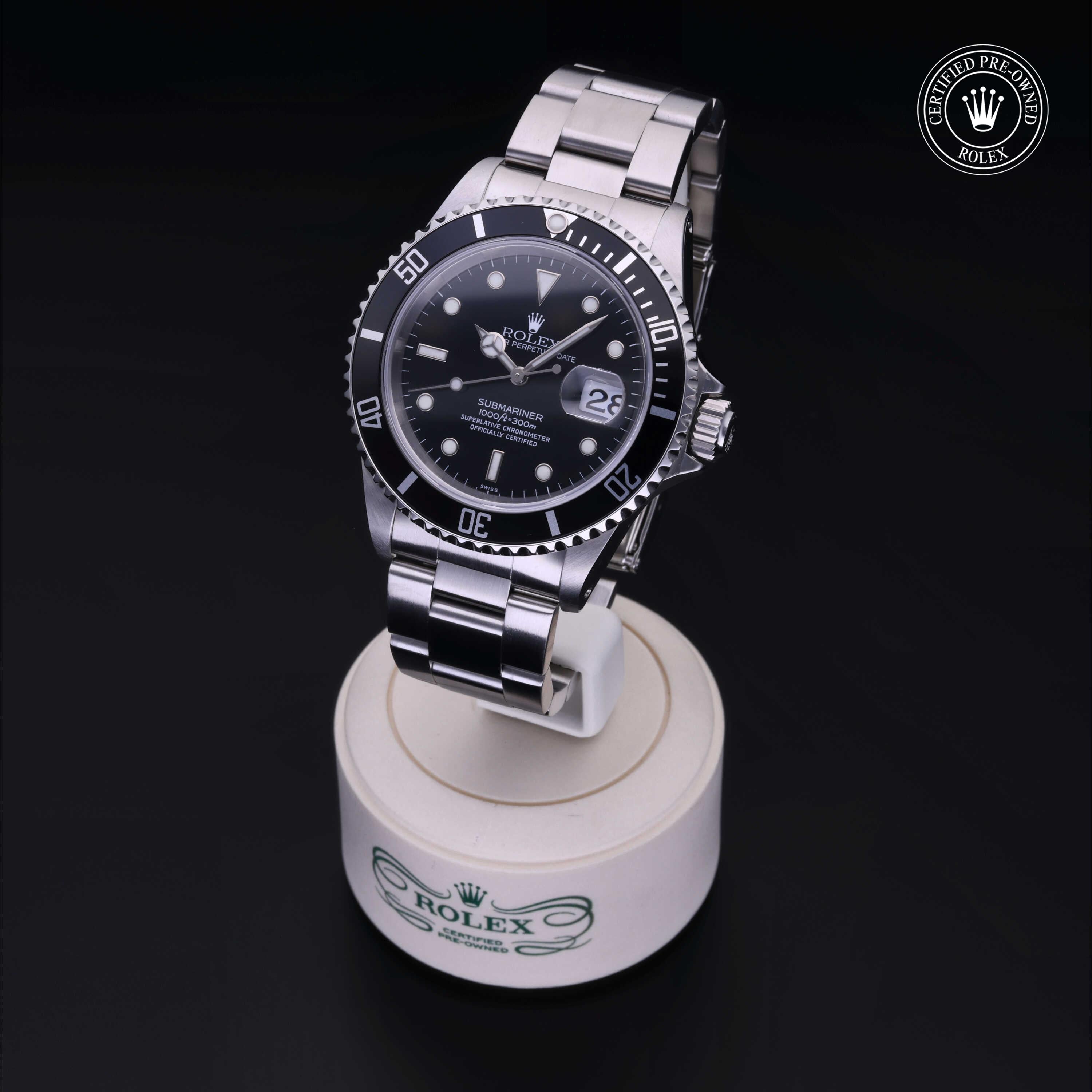 Stainless steel Rolex Submariner watch with black dial and date display, displayed on a branded stand with a 