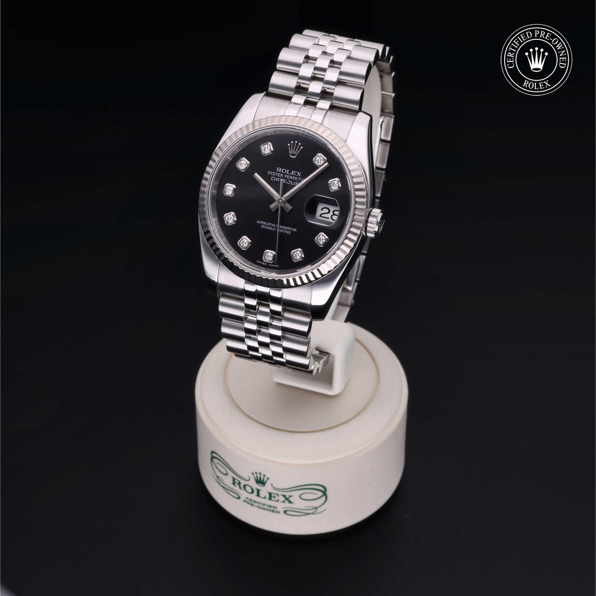 Luxury Rolex Certified Pre-Owned watch with a black dial and diamond hour markers on a silver Jubilee bracelet, elegantly displayed on a branded stand.