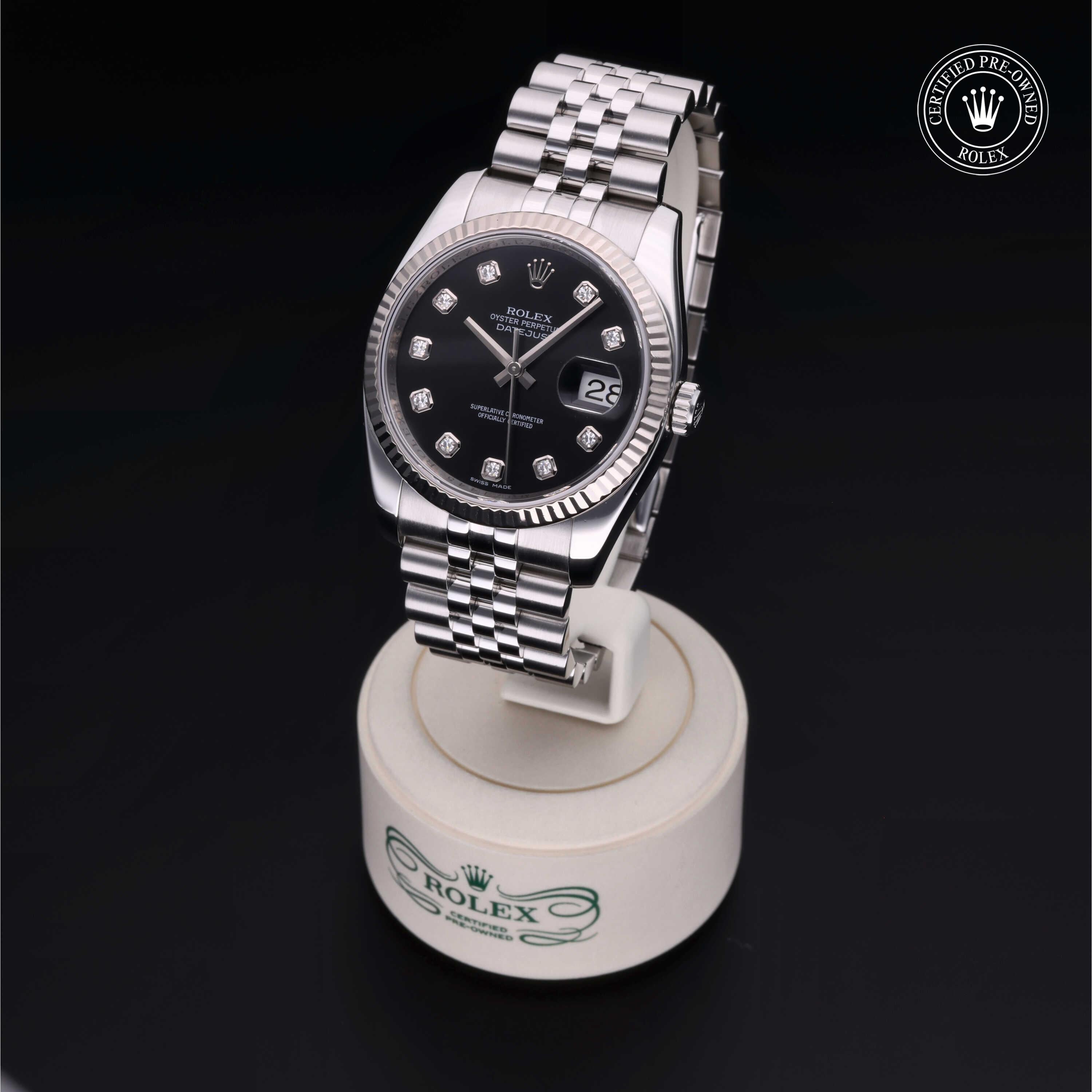 Luxury Rolex Certified Pre-Owned watch with a black dial and diamond hour markers on a silver Jubilee bracelet, elegantly displayed on a branded stand.