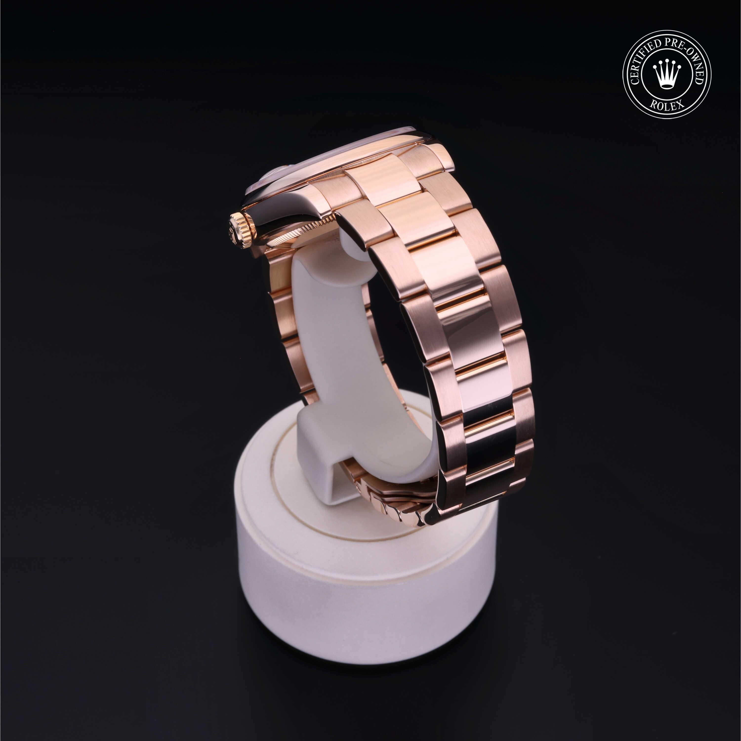 Rose gold luxury watch band displayed on a white stand with a verified pre-owned Rolex logo in the corner, emphasizing fine jewelry and certified quality.