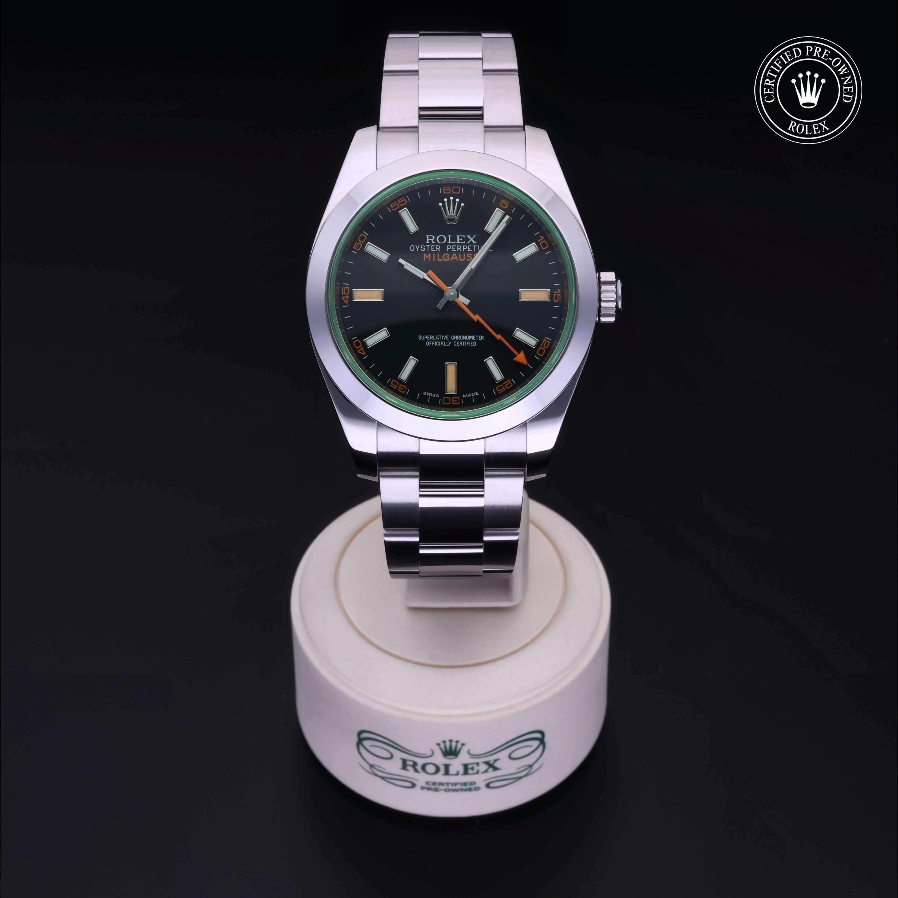 Rolex Milgauss luxury watch with stainless steel bracelet displayed on a white stand showcasing its polished design and certified pre-owned guarantee badge.