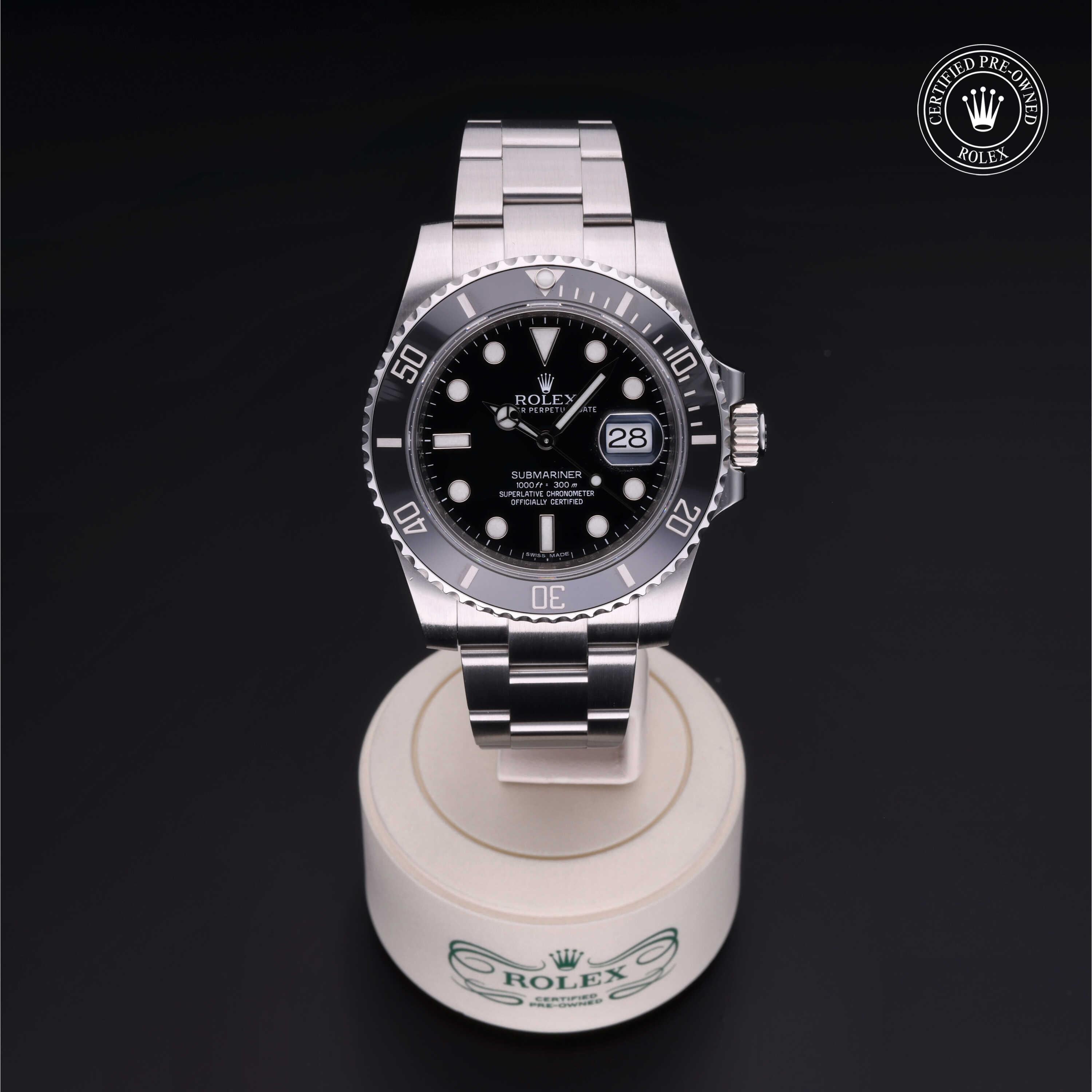 Rolex Submariner luxury watch with black dial and stainless steel bracelet displayed on a branded stand, featuring certified pre-owned Rolex logo.