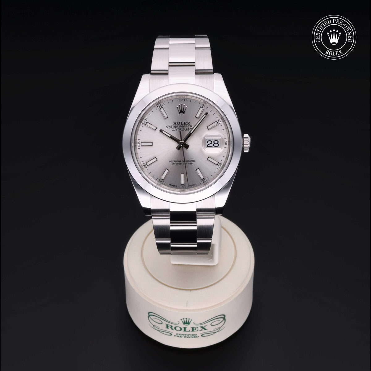 Silver Rolex Oyster Perpetual Date watch with stainless steel bracelet displayed on a white Rolex stand, showing the date and Certified Pre-Owned Rolex logo in top right corner.