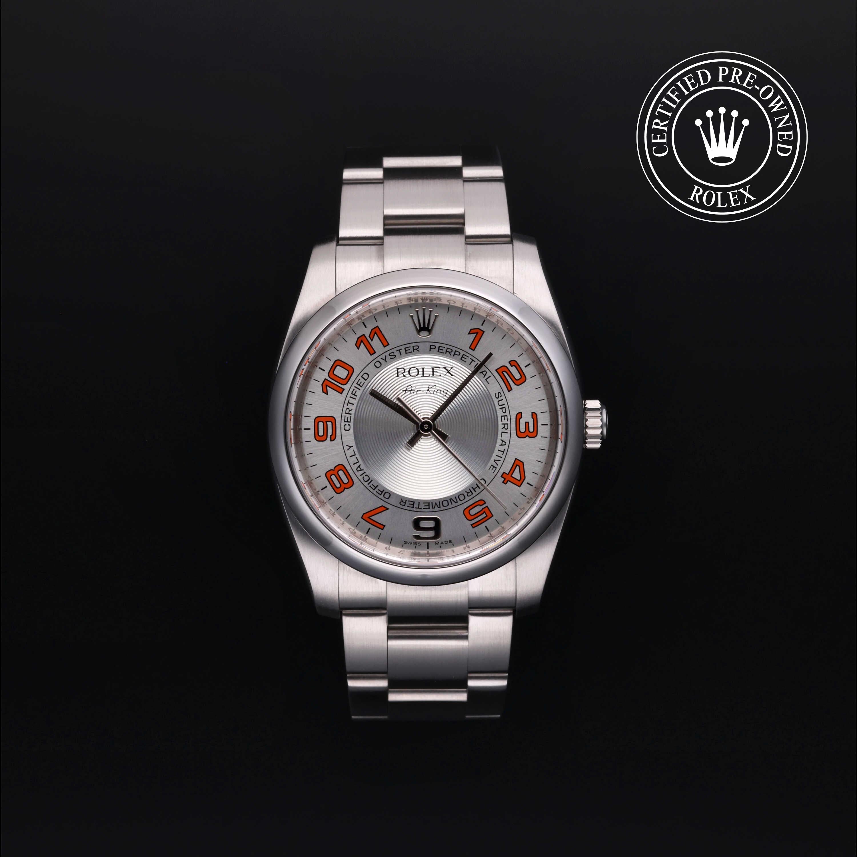 A Rolex Oyster Perpetual watch with a silver stainless steel case and bracelet, featuring a silver dial with orange Arabic numerals and black hands, set against a solid black background. A 'Certified Pre-Owned Rolex' emblem is visible in the top right corner.
