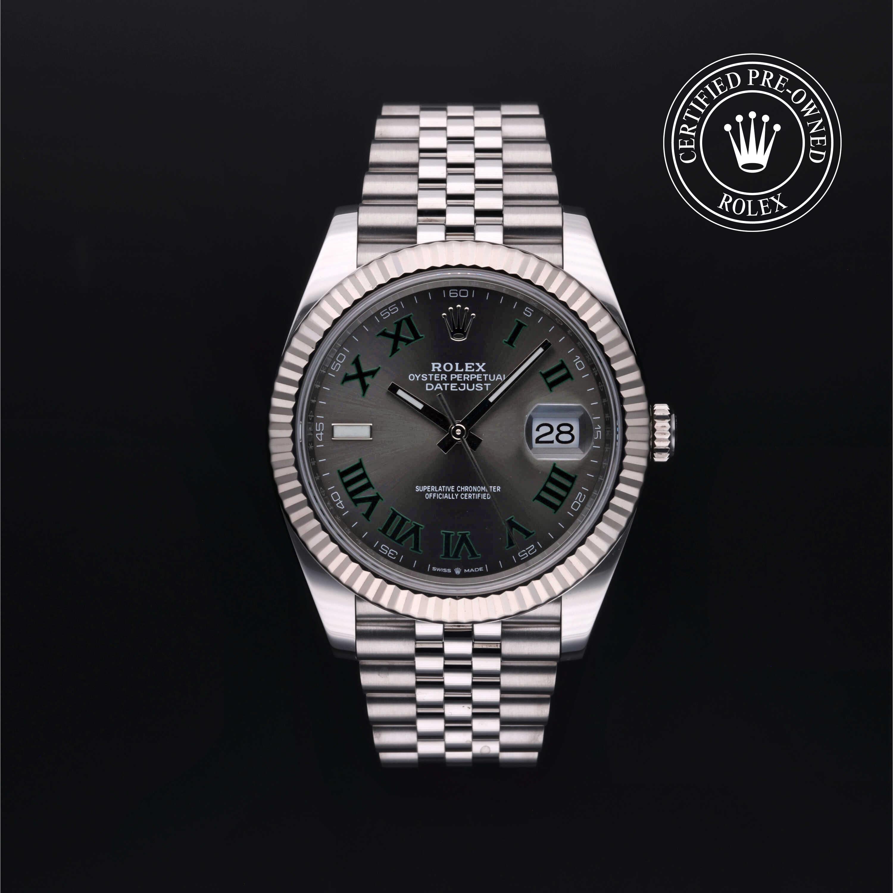 Rolex Datejust wristwatch with a silver stainless steel Oyster bracelet, fluted bezel, and dark gray dial with Roman numeral hour markers, shown on a black background with a 'Certified Pre-Owned Rolex' badge in the top right corner.