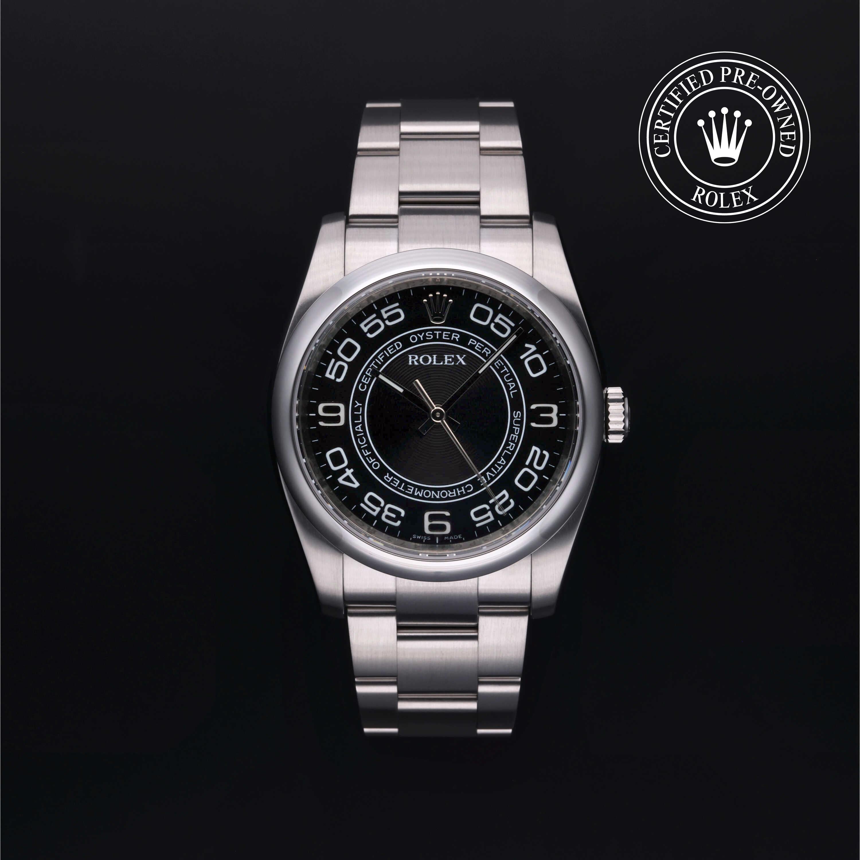 A Rolex stainless steel wristwatch with a black dial and integrated metal bracelet, shown on a black background with a 'Certified Pre-Owned Rolex' emblem in the top right corner.