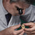 Man with Salt and pepper Hair Assessing Gold Rolex Watch