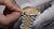 One White Gloved and One Ungloved Hand Adjusting a Two-Tone Yellow and White Gold Rolex Watch