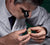 Man with Salt and Pepper Hair Inspecting a Rolex Watch for Repair